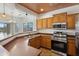 Updated kitchen with stainless steel appliances, wooden cabinets, breakfast bar and view into the dining area at 25617 W St James Ave, Buckeye, AZ 85326