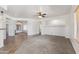 Open-concept living room with plush carpet, white walls, and views into other living spaces at 25617 W St James Ave, Buckeye, AZ 85326