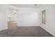 Carpeted Living room featuring neutral colors and a large window for natural light at 25617 W St James Ave, Buckeye, AZ 85326
