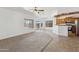 Open-concept living area seamlessly blending carpet and tile flooring with a view of the kitchen at 25617 W St James Ave, Buckeye, AZ 85326