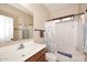 This bathroom offers a large mirror, cabinet, and shower with white tiling at 2614 W Fawn Dr, Phoenix, AZ 85041