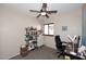 This bedroom offers a ceiling fan, window, and is decorated with a bookshelf and desk at 2614 W Fawn Dr, Phoenix, AZ 85041