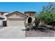 Charming single-story home featuring a two-car garage and desert landscaping under a clear blue sky at 2614 W Fawn Dr, Phoenix, AZ 85041