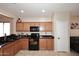Functional kitchen boasts a black oven and microwave, paired with ample wood cabinetry for storage solutions at 2614 W Fawn Dr, Phoenix, AZ 85041