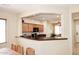 Open concept area featuring kitchen bar, dining table, and comfortable seating, all well-lit at 2614 W Fawn Dr, Phoenix, AZ 85041