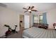 Bedroom featuring a ceiling fan and an adjacent bathroom, offering both comfort and convenience at 2614 W Fawn Dr, Phoenix, AZ 85041
