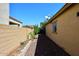 View of the side yard with rock bed, plants, and vegetable garden at 2614 W Fawn Dr, Phoenix, AZ 85041