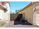 This side yard has a metal and wood gate with rock bed at 2614 W Fawn Dr, Phoenix, AZ 85041