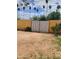 Fenced backyard with a gate surrounded by desert vegetation at 3041 E Osborn Rd, Phoenix, AZ 85016