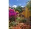 Secluded backyard oasis featuring vibrant purple plants and a small tree at 3041 E Osborn Rd, Phoenix, AZ 85016