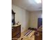 Modest bedroom with tiled floors and a large dresser at 3041 E Osborn Rd, Phoenix, AZ 85016
