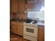 Traditional kitchen with double sink, standard appliances, and wooden cabinets at 3041 E Osborn Rd, Phoenix, AZ 85016
