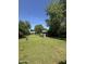 Spacious backyard with a well-maintained lawn, storage shed, and mature trees offering shade at 313 E 15Th St, Tempe, AZ 85281