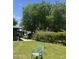 Backyard featuring a mature tree, clothesline, patio, and grassy area perfect for outdoor relaxation at 313 E 15Th St, Tempe, AZ 85281