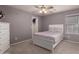 Bedroom with carpet flooring, window, ceiling fan, and door to closet at 3443 W Saint Anne Ave, Phoenix, AZ 85041
