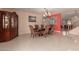 Formal dining room featuring tile floors, elegant chandelier, and decorative furnishings at 3443 W Saint Anne Ave, Phoenix, AZ 85041