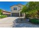 Two story home featuring an attached garage, desert landscaping, and an ADT security system at 3443 W Saint Anne Ave, Phoenix, AZ 85041