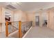 Upstairs hallway with wood railing offers access to bedrooms at 3443 W Saint Anne Ave, Phoenix, AZ 85041