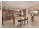 Spacious kitchen with granite countertops, island with seating, and stainless steel appliances at 3443 W Saint Anne Ave, Phoenix, AZ 85041