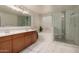Main bathroom with dual sinks, garden tub, and tile and glass walk-in shower at 3443 W Saint Anne Ave, Phoenix, AZ 85041