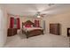 Main bedroom with carpet, ceiling fan, matching night stands, and large bed frame at 3443 W Saint Anne Ave, Phoenix, AZ 85041
