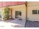 Covered patio area with a sliding glass door leading inside and a pea gravel area at 357 E Thomas Rd # A112, Phoenix, AZ 85012