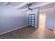Bedroom with wood-look tile flooring, ceiling fan, and a sliding-door closet at 357 E Thomas Rd # A112, Phoenix, AZ 85012