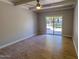 Bright bedroom featuring wood-look tile floors and a sliding glass door to the backyard at 357 E Thomas Rd # A112, Phoenix, AZ 85012