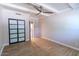 Bedroom with wood-look tile flooring, ceiling fan, and a sliding-door closet at 357 E Thomas Rd # A112, Phoenix, AZ 85012