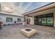 Contemporary backyard with a paved patio, modern fire pit, and ample outdoor seating area at 3950 E Augusta Ave, Queen Creek, AZ 85142