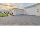 Immaculate property with a large driveway, three-car garage, and lush landscaping at 3950 E Augusta Ave, Queen Creek, AZ 85142