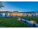 Stunning single-story home with manicured front yard, stone accents, walkway lighting, and lush green lawn at 3950 E Augusta Ave, Queen Creek, AZ 85142