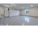 Spacious garage with epoxy flooring, overhead lighting, and an insulated garage door at 3950 E Augusta Ave, Queen Creek, AZ 85142