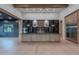Open-concept kitchen with dark cabinetry, stainless steel appliances, large island, and wood floors at 3950 E Augusta Ave, Queen Creek, AZ 85142