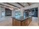 Modern kitchen features an island, open layout, wooden ceiling beams, fireplace and access to the outdoor living space at 3950 E Augusta Ave, Queen Creek, AZ 85142