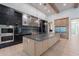 An airy kitchen features stainless appliances, stone countertops, professional cooktop, and pendant lighting at 3950 E Augusta Ave, Queen Creek, AZ 85142
