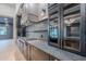 Chef's kitchen features a modern gas range, custom cabinets, stone counters, and stainless vent hood at 3950 E Augusta Ave, Queen Creek, AZ 85142