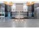 Sleek kitchen island with a sink, stainless steel appliances, stone countertops, and wooden beams on the ceiling at 3950 E Augusta Ave, Queen Creek, AZ 85142
