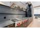 A gourmet kitchen features stone countertops, stainless steel appliances, and a professional-grade range hood at 3950 E Augusta Ave, Queen Creek, AZ 85142