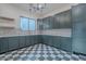 Laundry room with gray-green cabinets, quartz countertops, a mosaic backsplash, and checkered tile floors at 3950 E Augusta Ave, Queen Creek, AZ 85142