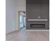 Modern living room featuring an electric fireplace, wood flooring and decorative accent wall at 3950 E Augusta Ave, Queen Creek, AZ 85142