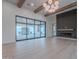 Stunning living room featuring an electric fireplace, modern light fixture, and large sliding glass doors to the backyard at 3950 E Augusta Ave, Queen Creek, AZ 85142