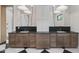 Bright bathroom features a dual sink vanity with stone countertop, modern mirrors, and black and white floor tiles at 3950 E Augusta Ave, Queen Creek, AZ 85142