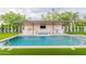 Luxurious pool with outdoor kitchen featuring a built-in grill, bar seating, and mounted TV at 3950 E Augusta Ave, Queen Creek, AZ 85142