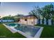 Stunning pool area featuring a waterfall feature, outdoor kitchen, and beautiful landscaping at 3950 E Augusta Ave, Queen Creek, AZ 85142
