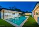 Backyard swimming pool with a waterfall feature, adjacent to the covered outdoor kitchen and spa at 3950 E Augusta Ave, Queen Creek, AZ 85142