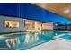 Elegant pool with waterfall feature, seamlessly integrated with the covered outdoor kitchen and living spaces at 3950 E Augusta Ave, Queen Creek, AZ 85142