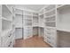 Spacious walk-in closet with custom white shelving, drawers, and modern matte black hardware at 3950 E Augusta Ave, Queen Creek, AZ 85142