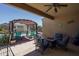 Outdoor patio with a pergola, fire table, seating and views of the pool and backyard at 4001 N 300Th Ln, Buckeye, AZ 85396