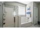 Bright bathroom showcasing a shower and tub with tiled floors and ample natural light at 4001 N 300Th Ln, Buckeye, AZ 85396